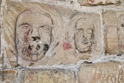 Carved stone faces and symbols in St Nicholas of Bari church in the old town of Aviles city, Asturias