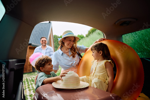 Photos Happy parents and their kids getting ready family road trip in summer