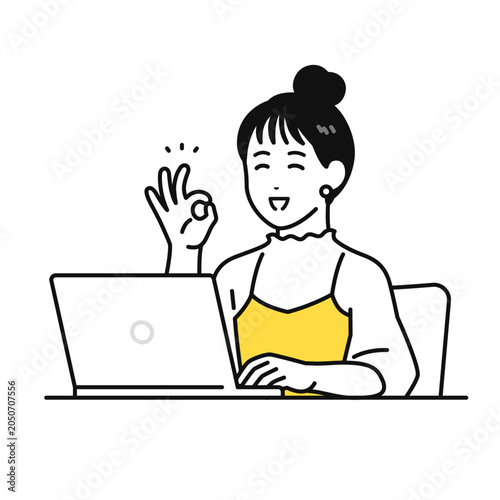 pcの前でokサインをするまとめ髪の若い女性