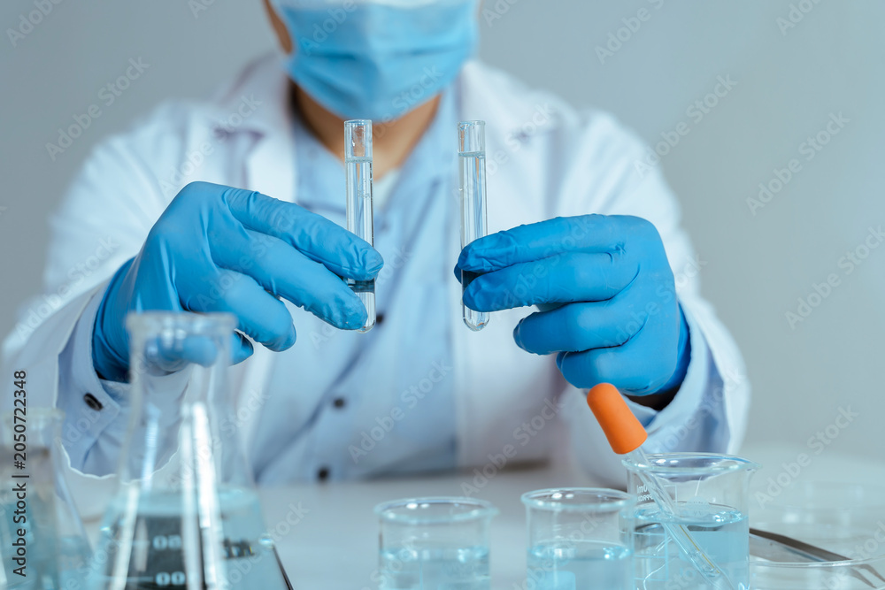 Fototapeta premium Scientist Comparing Test Tube Samples in Laboratory
