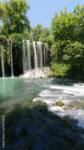 Hidden waterfall in forest during summer