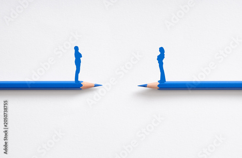 Photos Couple on pencils facing conflict and relationship distance
