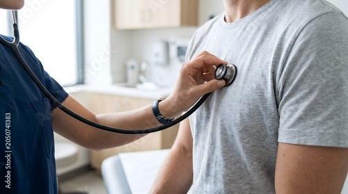 A healthcare professional performing a routine checkup using a stethoscope on a patient.