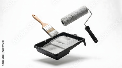 Painting tools floating in air with roller and brush