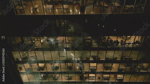 Office building view at night with lights on in multiple rooms