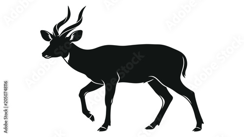 Photography Antelope silhouette stands in a profile view to showcase the elegant curvature of its horns and muscular body structure