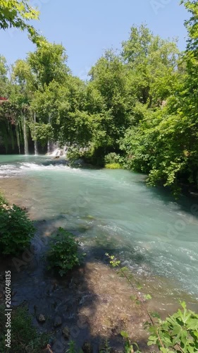 Hidden natural waterfall deep in green forest