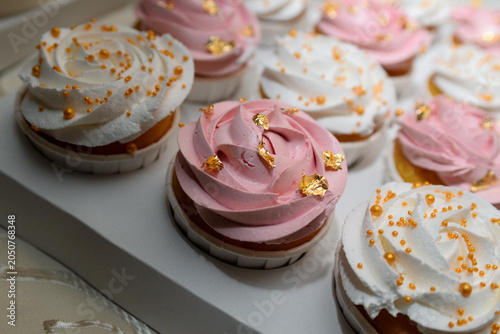close-up shot of pink and white muffins with tiny golden stars