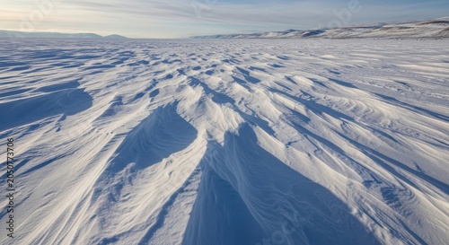 Frozen Snow Field Shaped by Wind Under a Bright Sky