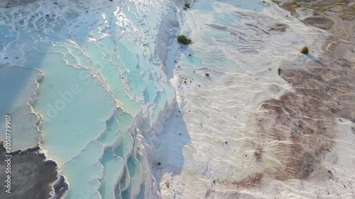 Explore the mesmerizing beauty of Pammukale, Turkey, showcasing the remarkable white travertine terraces and serene turquoise pools. Perfect location for relaxation and sightseeing.