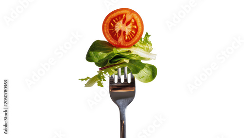 Fresh salad leaves and tomato slice on fork