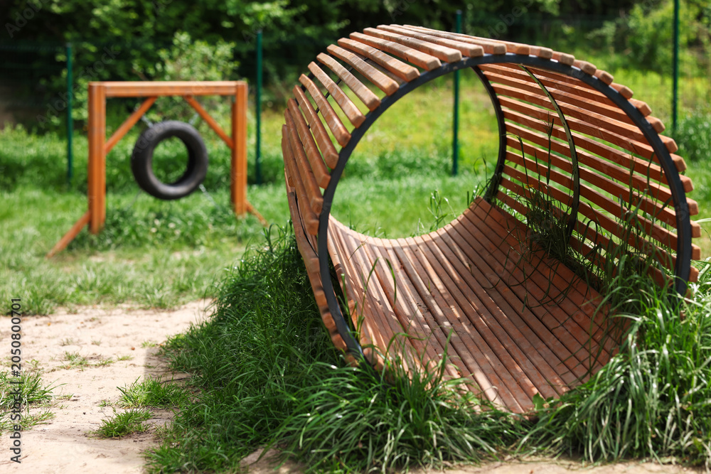 Fototapeta premium Wooden tunnel at training ground in dog park