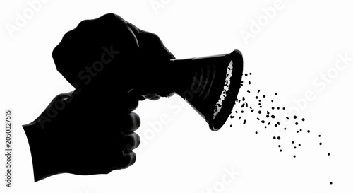 Silhouette of hands holding a salt shaker, dispensing spices onto a white background.