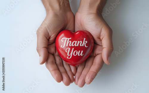 Top-view image holding a heart with the text “Thank You