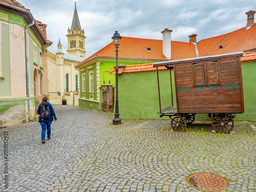 Female tourist exploring medieval streets of Sighisoara, Romania