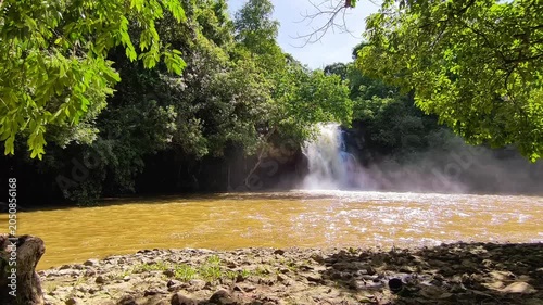Wide View of Tropical Waterfall and River After Heavy Rainfall in Green Forest