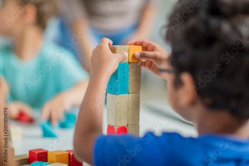 Children playing with building blocks in kindergarten