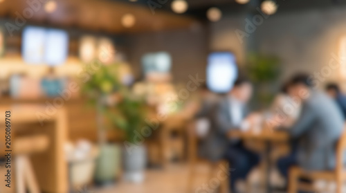 фотографія Blurred coffee shop interior background people sitting wooden tables bright mode