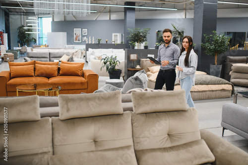 Foto Furniture store consultant assisting female customer shopping
