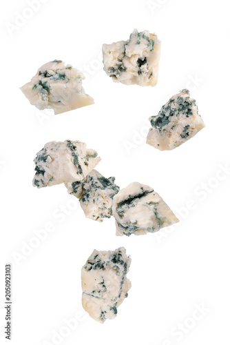 Abstractly chopped pieces of blue cheese fall in space. Isolated on white.