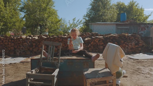 A child playing with a doll in nature, playing with a doll, a girl with a doll