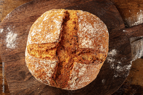 Homemade artisan sourdough bread loaf on a rustic wooden cutting board