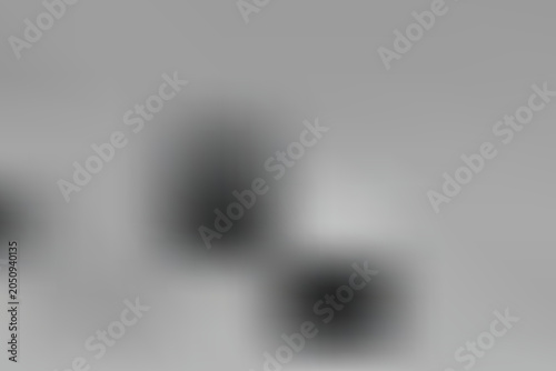 Three blurred objects on a gradient background transitioning from dark to light