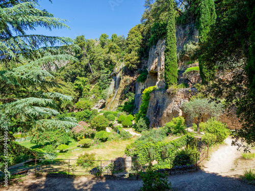 Villecroze Park in the Haut-Var region, a verdant setting with Mediterranean species, an oasis of coolness along a stream at the foot of a tufa cliff with caves