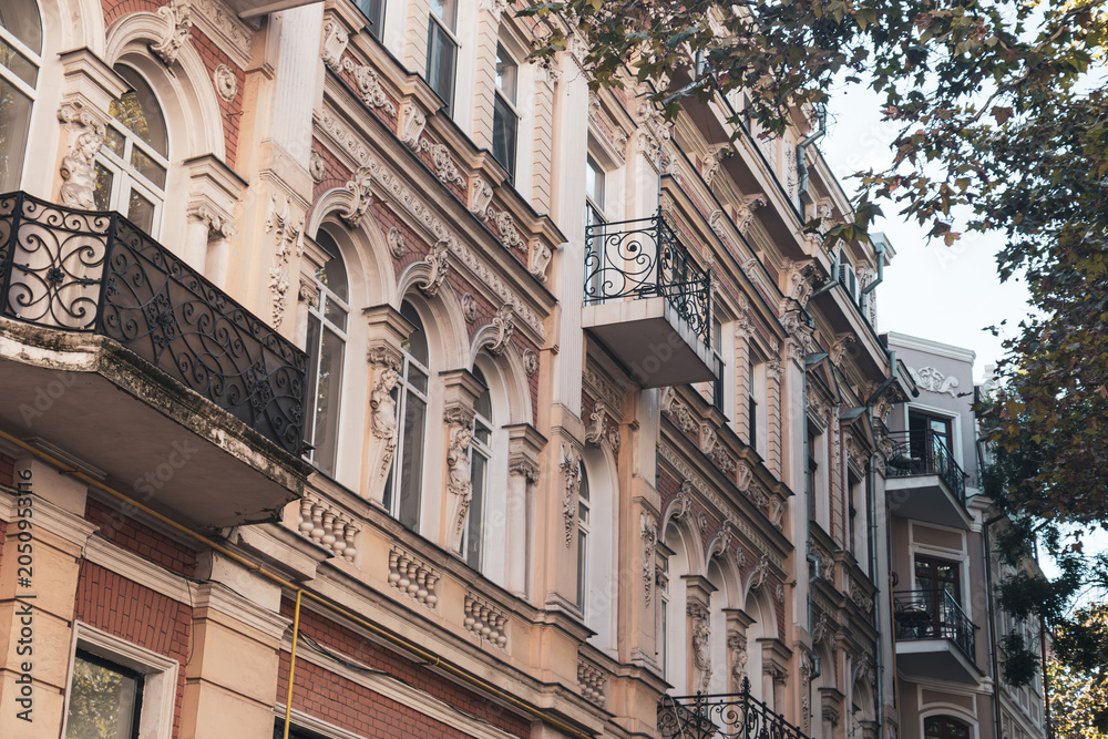 Fototapeta premium Historic buildings with detailed balconies and classic architecture in urban setting