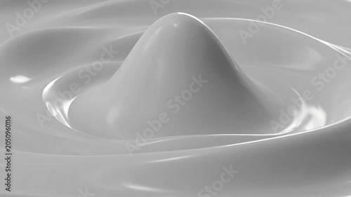 A smooth white liquid surface creates elegant concentric circular ripples