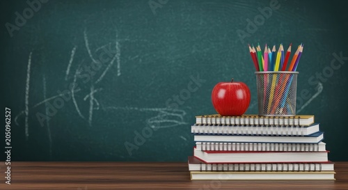 Back to school stack of books red apple and colorful pencils on wooden desk education concept