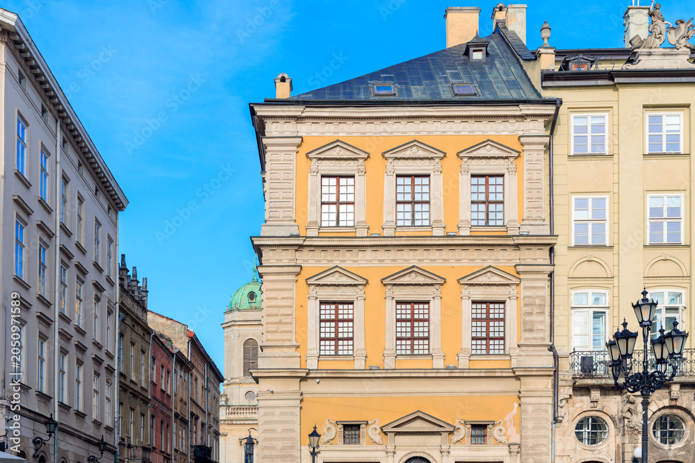 Obraz premium Charming European old town street with historic buildings and blue sky