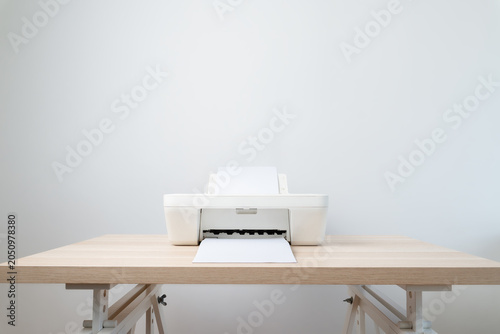 Minimal White Printer On Wooden Desk With Paper in the in and out tray In Modern Office Workspace