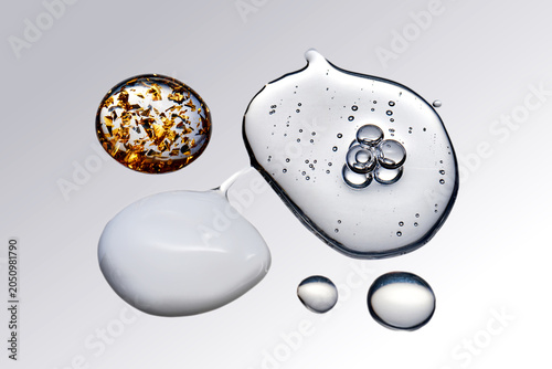 Skincare product drops with serum texture and gold flakes