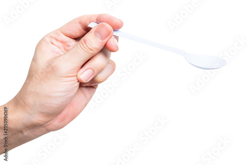 Male hand holding a white plastic spoon isolated on white background.