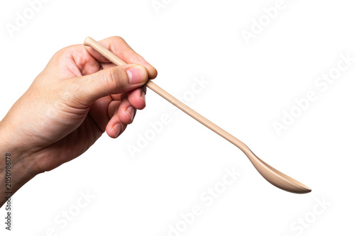 Male hand holding a brown plastic spoon isolated on white background.