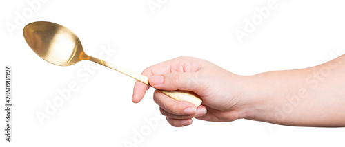isolated of a women's hand holding a golden steel spoon.