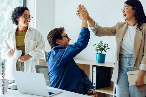 Business colleagues celebrate success with a high five