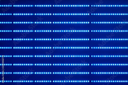 A structured array of dense blue circular LED light emitters arranged in parallel horizontal rows on a dark blue background.