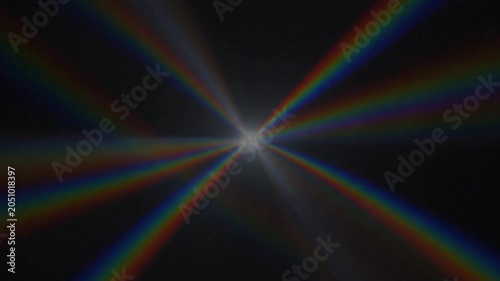 Flashing Rainbow Starburst Lens Flare And Prismatic Light Rays Radiating On Black Background