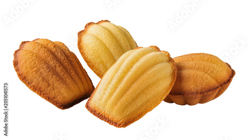 Foto Four golden brown madeleine cookies with shell pattern