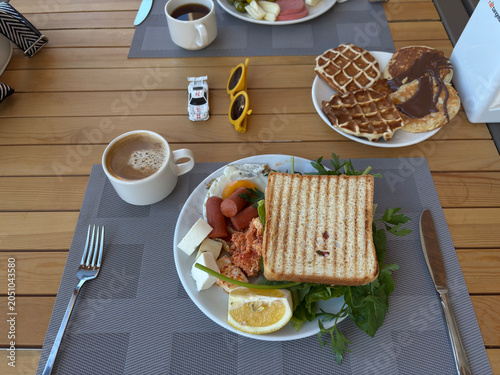 Restaurant breakfast served on a table with fresh dishes, coffee, and juice, elegant morning meal in a cozy dining setting, healthy and delicious food concept for hotel or cafe lifestyle.