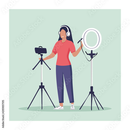 Woman creating content with microphone, ring light and smartphone