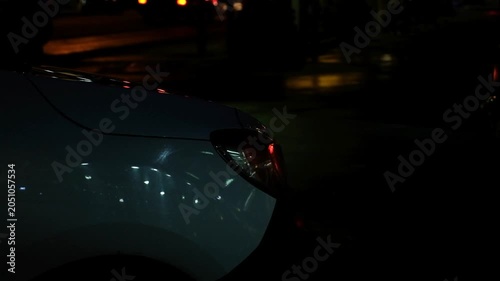 Cinematic close up of a car turn signal flashing on a city street