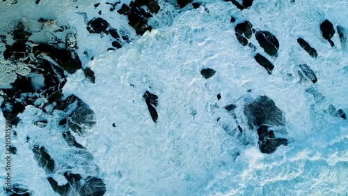 Top down view of ocean swells rolling towards the coastline The Concept of environment and power