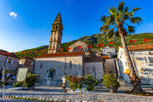 The striking stone bell tower and facade of the historic St Nicholas Church in the coastal town of Perast