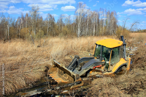 Backhoe Stuck in Muddy Wilderness