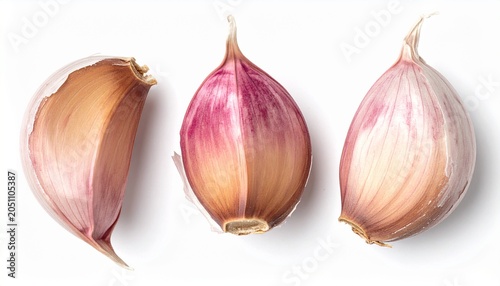 Three garlic cloves isolated on white background, close-up view.