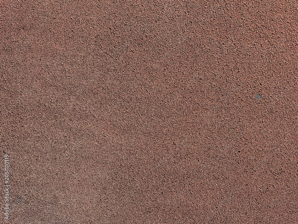 Fototapeta premium A brown surface displays fine textures of sand and minerals found in natural earth, highlighting its unique patterns
