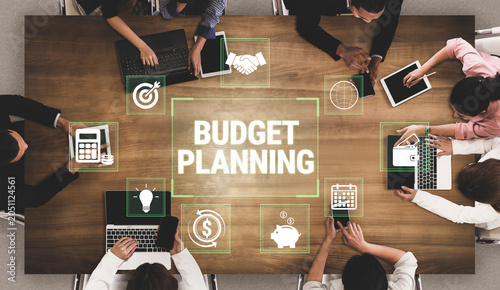 Foto Diverse Teams Engaging in Collaborative Budget Planning and Strategy Development Around a Conference Table with Digital Devices Fluxor